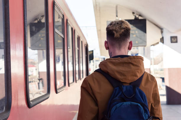 istock Young back traveler with backpack in the railway,travel concept. 1308452098