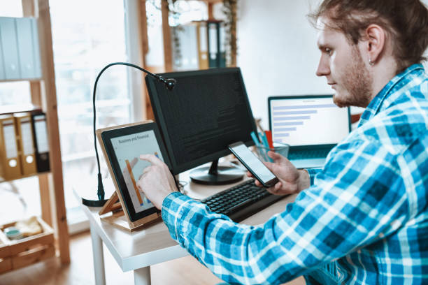 istock Male Hipster Office Worker Checking Stock Market While Working In Office 1308452266
