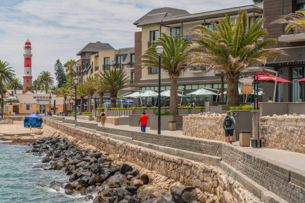 promenade in swakopmund. in the background the lighthouse. - south africa coastline sea wave imagens e fotografias de stock