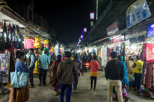 Kolkata, India - February 7, 2021: A crowded local market under a bridge in Sodepur, Kolkata.  This depicts city life of Kolkata.