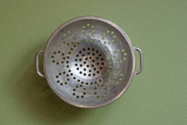 one old gray metal bowl a colander