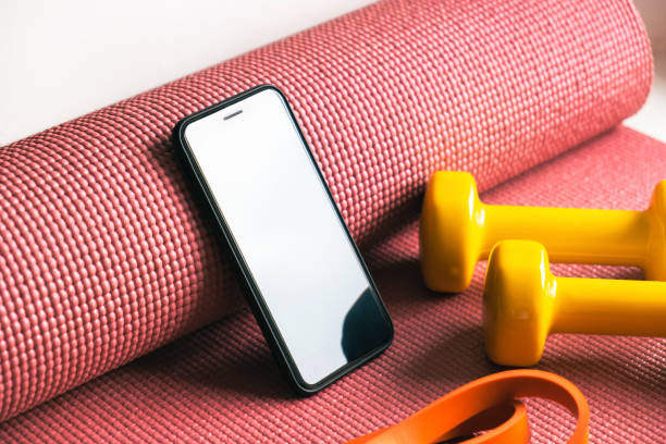 istock Training, doing fitness at home in lockdown with phone app. 1308454823