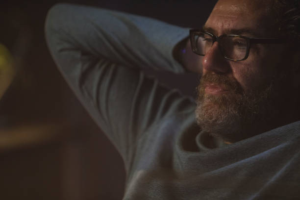 istock Man leaned back in chair, with hands behind head, contemplating 1308455101