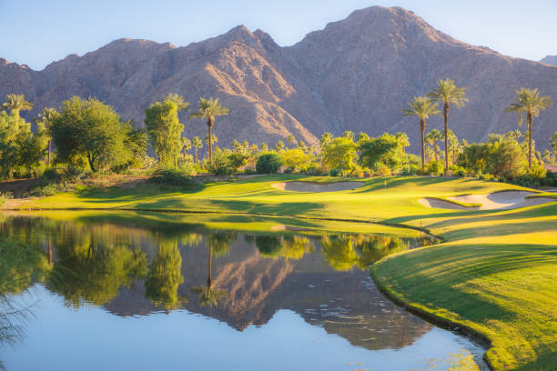 Indian Wells Golf Course, California Beautiful golden light over Indian Wells Golf Resort, a desert golf course in Palm Springs, California, USA with view of the San Bernardino Mountains. palm desert pool stock pictures, royalty-free photos & images