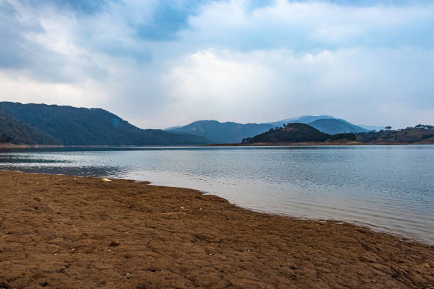 lake calm water with mountain background at day from flat angle image is taken at umiam lake shillong meghalaya india.