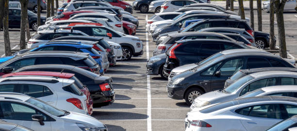 istock Facing car parking outside on a sunny day 1308458097