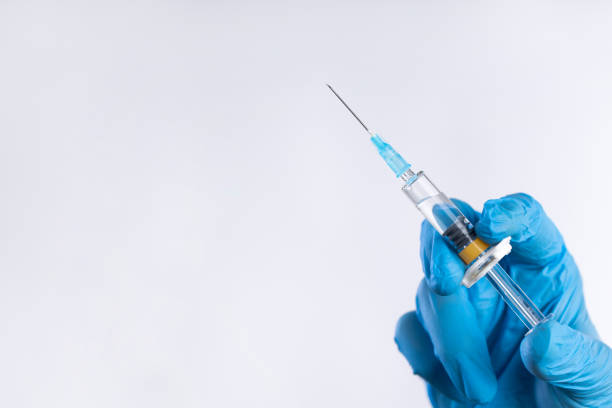 ręka lekarza w rękawiczce trzymająca strzykawkę - syringe injecting surgical needle medical injection zdjęcia i obrazy z banku zdjęć