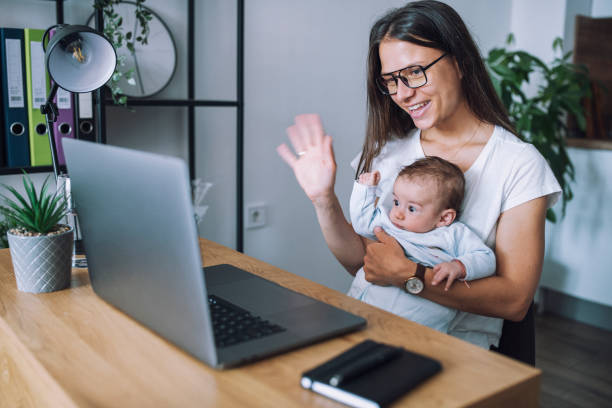 istock Multi-tasking mother at her home office. 1308459272