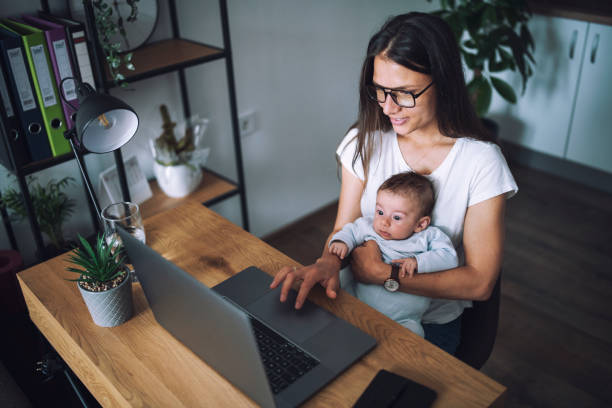 istock A mom trying to work from home while carrying her newborn son. 1308459275
