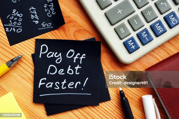 Pay Off Debt Faster Handwritten Memo And Calculator Stock Photo - Download Image Now