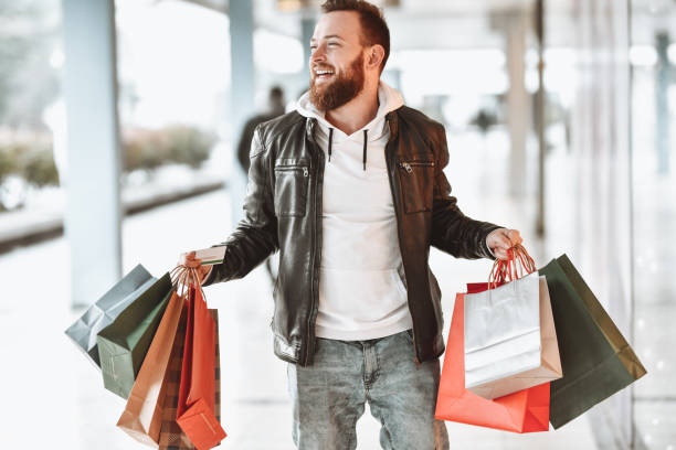 istock Smiling Modern Male Enjoying Shopping Time 1308460411