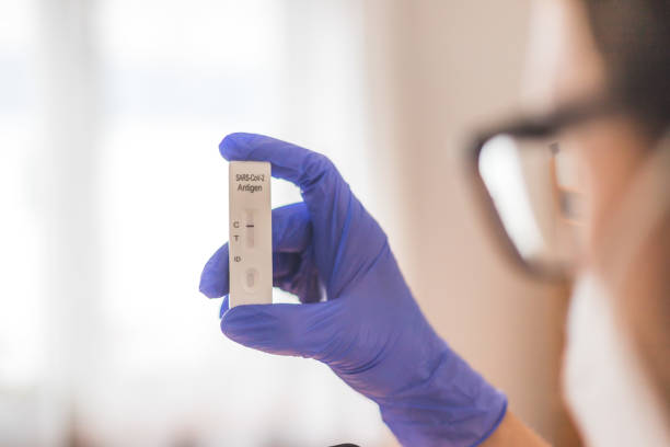 istock Young biologist or pharmacist is holding a covid-19 or corona antigen test 1308460751