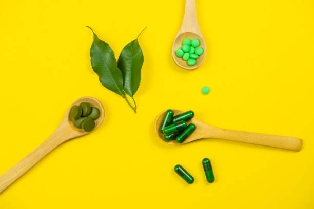 istock Mixed herbal tablets on a wooden spoon. Food supplement. Selective focus 1308460847