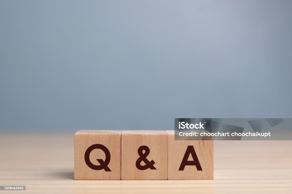 wood block cube with alphabet Q&A on wooden table,Questions and answers concept. Q and A Stock Photo