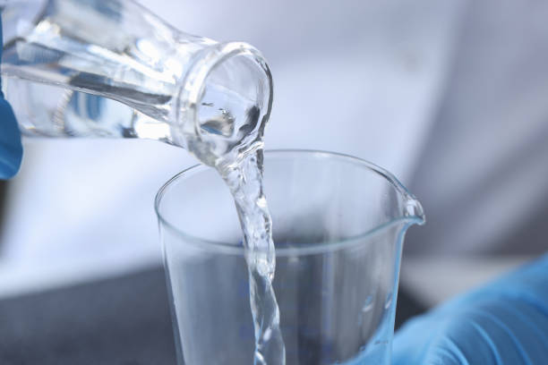istock Clear liquid is poured from glass bottle 1308463998