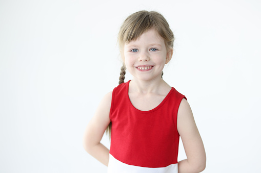 Portrait of smiling little girl with blond hair. How to find an approach to raising young children concept