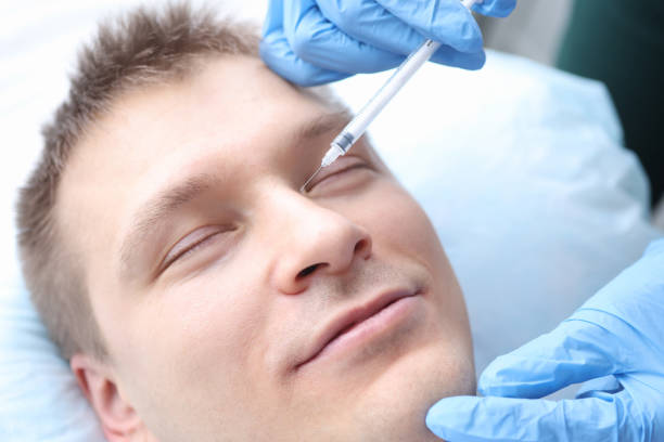 istock Man is given rejuvenating injection in his face 1308464063