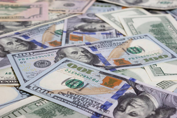 istock Bundle of dollars on the table close-up - texture, background 1308469713
