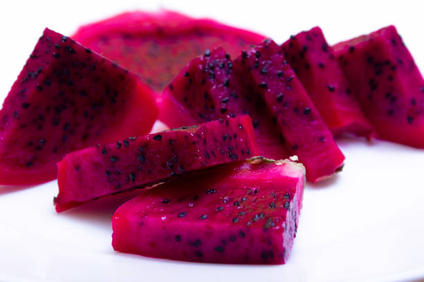 Juicy cut fruits of edible dragon fruit cactus, pitahaya, texture close up Juicy cut fruits of edible dragon fruit cactus, pitahaya - on white background, texture close up dragon fruit flower stock pictures, royalty-free photos & images