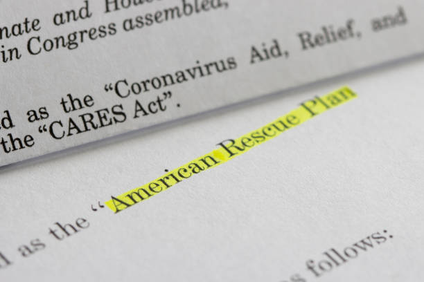 American Rescue Plan Act of 2021 and CARES Act Closeup of the documents of both the Cares Act (Coronavirus Aid, Relief, and Economic Security Act) and the American Rescue Plan Act (ARPA) of 2021. A comparison between two acts. bill legislation photos stock pictures, royalty-free photos & images