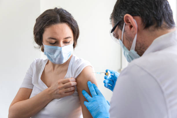 istock Doctor applying a vaccine on a woman's arm 1308472562