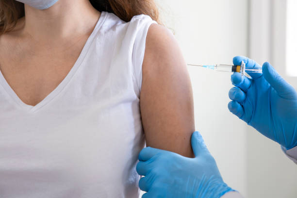 istock Doctor applying a vaccine on a woman's arm 1308473507