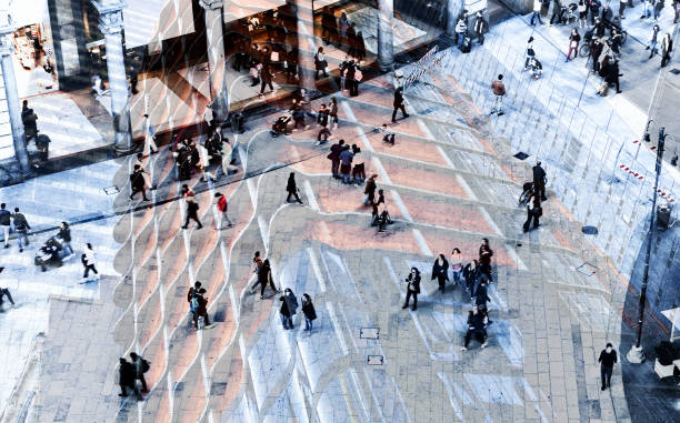 istock Abstract image of people walking on a street. 1308473550