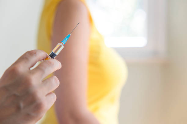 istock Doctor applying a vaccine on a woman's arm 1308473606