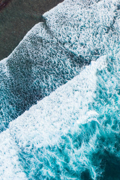 istock Big ocean waves hitting a coral reef. View from above. 1308473987