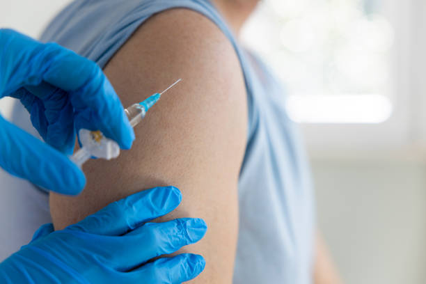 istock Young man getting a vaccine in a doctor's office 1308474514