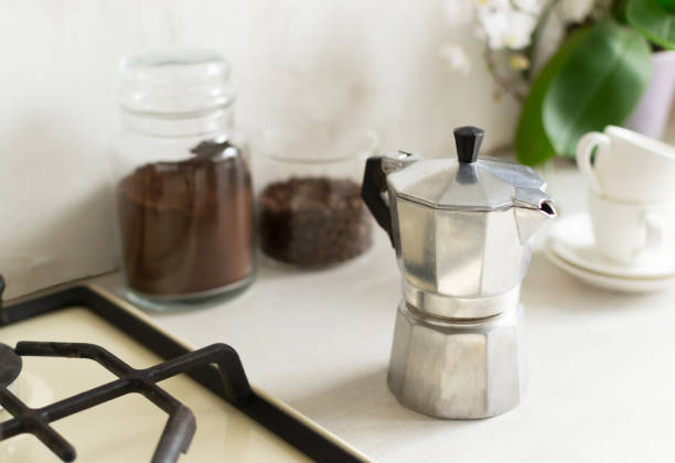 istock A geyser coffee maker is on the table next to coffee cans and espresso cups. 1308475120