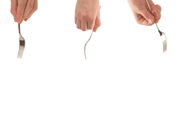 istock Fork in woman hand isolated on white. 1308475215