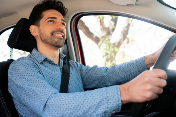 istock Man driving his car on way to work. 1308476055
