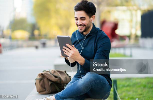 Young Man Having A Video Call On Digital Tablet Outdoors Stock Photo - Download Image Now