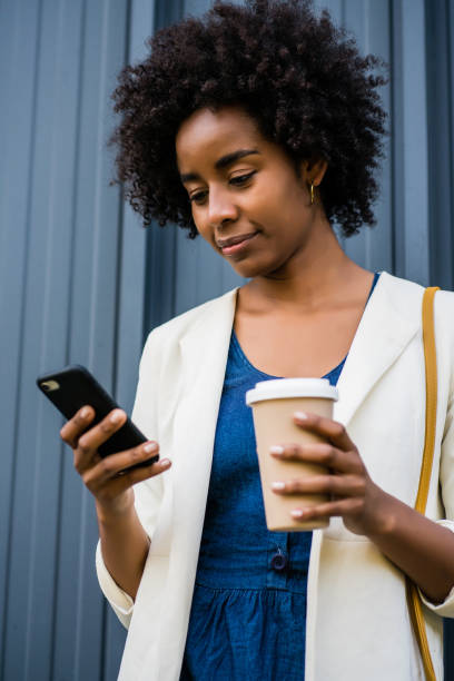 istock Business woman using her mobile phone outdoors. 1308476079