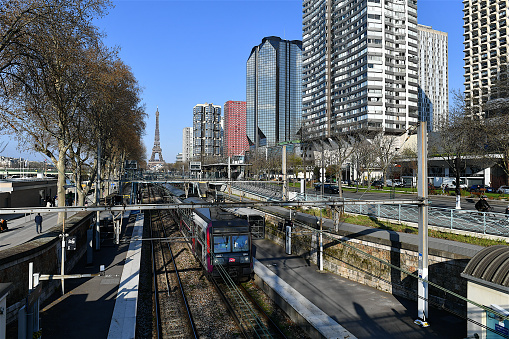 Paris, France-03 20 2021:A commuter train passing near the Beaugrenelle district or district of the Front de Seine in the 15th arrondissement of Paris which is a shopping and residential district built at the end of the 1970s.