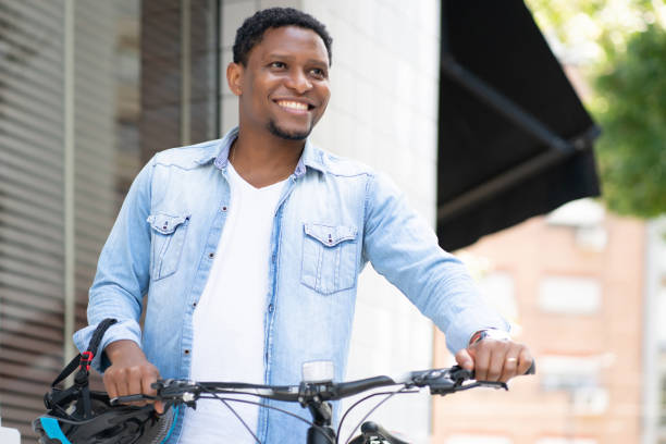 istock Man wearing a helmet while walking with a bicycle. 1308478305
