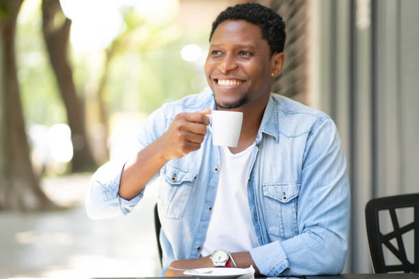 istock Man drinking coffee at coffee shop. 1308478307