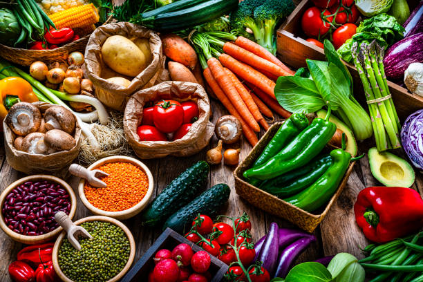 istock Healthy food: fresh organic vegetables and legumes on rustic wooden table 1308478987