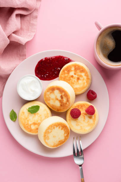istock Cottage cheese fritters, Syrniki with raspberry jam and sour cream 1308479084