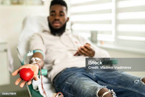 An Africanamerican Young Man Donating Blood In The Hospital Stock Photo - Download Image Now