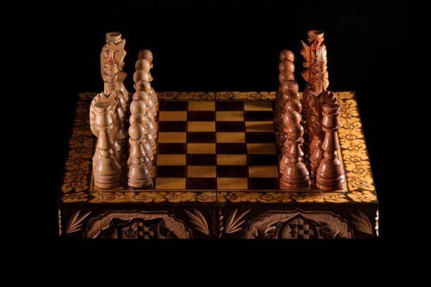 istock Vintage chess pieces are placed opposite each other before the opening 1308481467