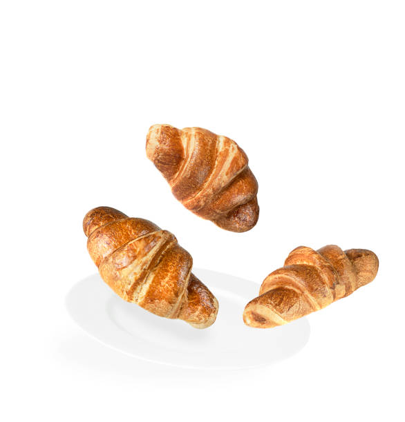 istock Levitation of three croissants on a white plate and white background. 1308481530