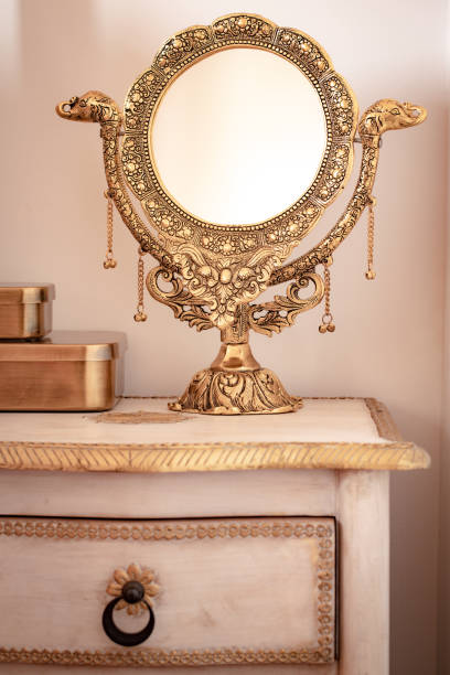 istock a beautifully decorated golden mirror standing on a stylish bedside table. Feminine elegance, warm colors 1308482598
