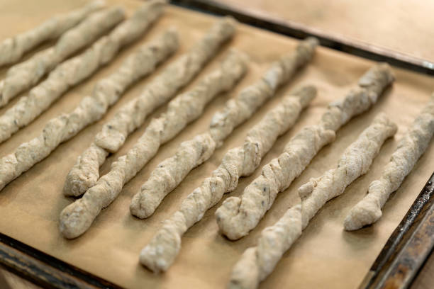 Crispy rye sticks sprinkled with flour. Rustic, laid out on a baking sheet.