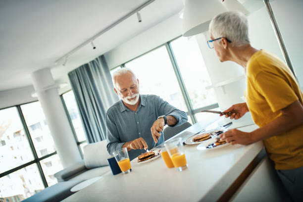 istock Mature couple having a breakfast at a kitchen counter. 1308487105