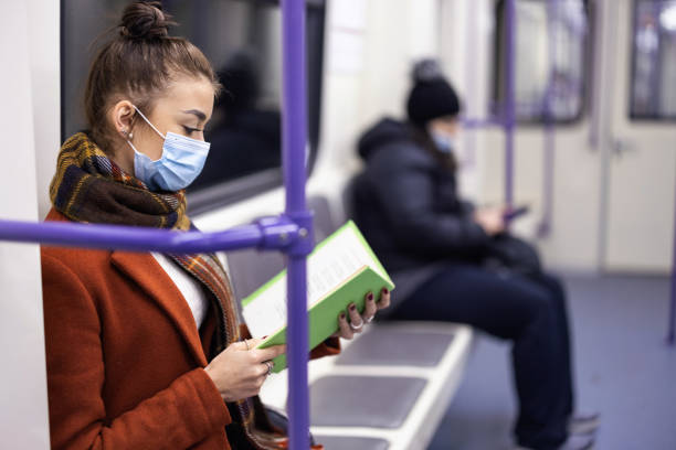 istock Girl reading book in the Subway 1308487196