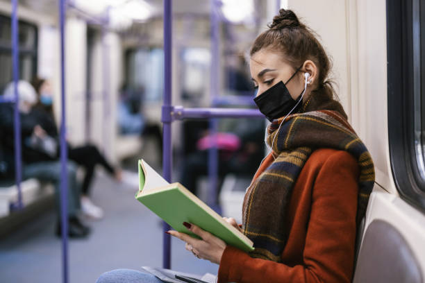 istock Girl reading book in the Subway 1308487197