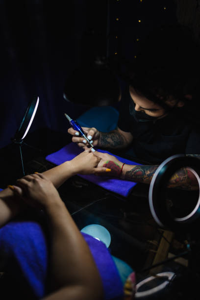 istock Manicurist working in a woman's hands 1308490426