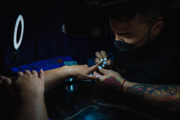 istock Manicurist man working in a woman's hands 1308490429
